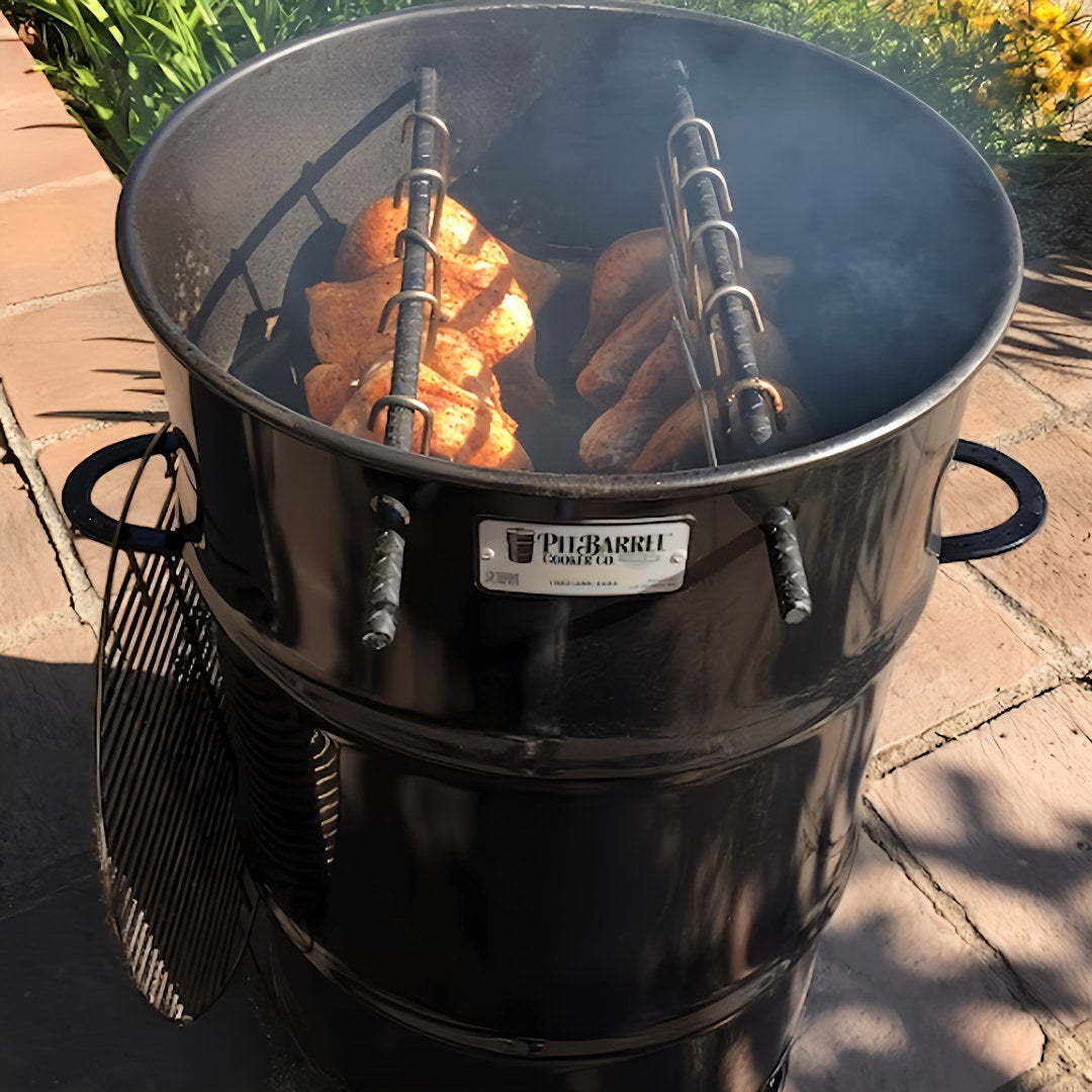 Pit Barrel Cooker with different types of meat hanging from the barrel