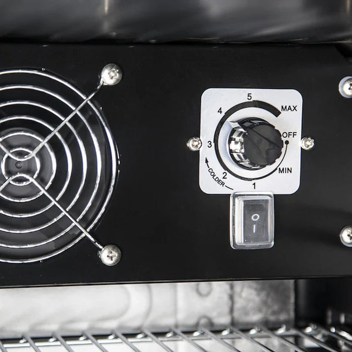 the inside of a bar fridge showing the internal fan and temperature control