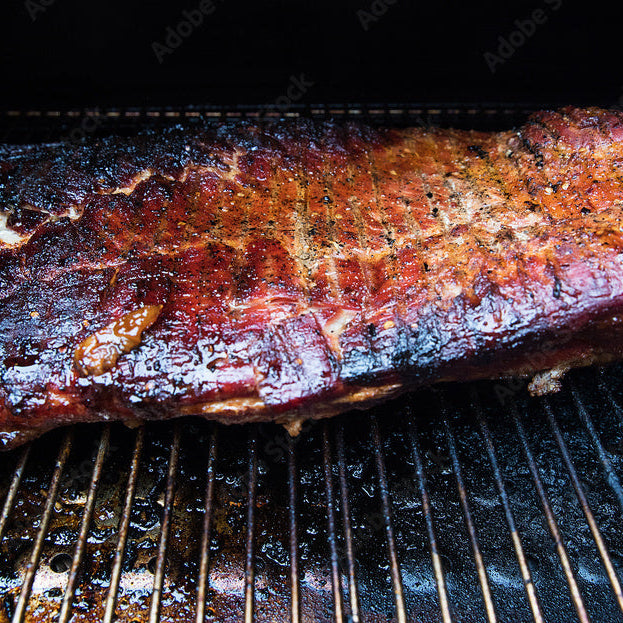 Portable Pellet Smoker, three views with smoker sitting on table, and lid open with food cooking