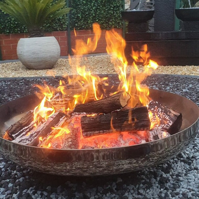 Outdoor fire pit with a raging fire inside it