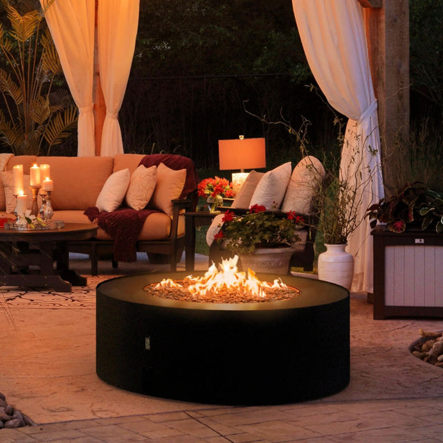 Fireplace Galio star in black sitting in outdoor area at night with flames roaring