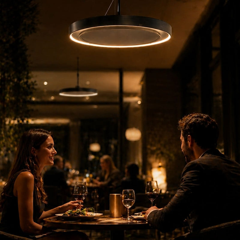Herschel Ibiza Zero-Light Outdoor Infrared Heater with LED Lighting above 2 people eating