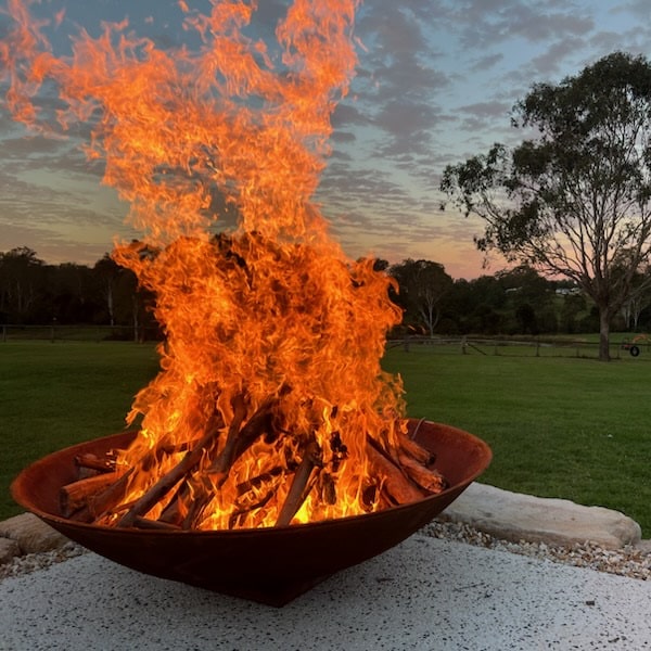 Mega cauldron 1500 mm with raging fire inside close up view