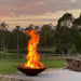 Mega cauldron 1500 mm with raging fire inside in a backyard