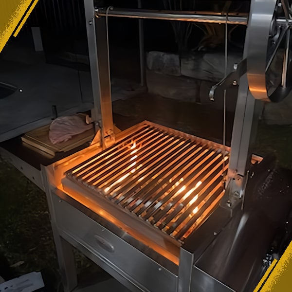 BBQ Parrilla grill with the firebox full of wood a light and the grill pushed right to the bottom