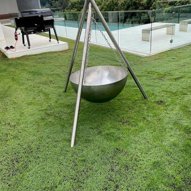 Tripod Fire Pit | The Inferno Tower | Cast Iron & Stainless Steel in the stainless steel version next to a pool
