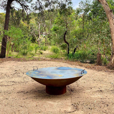 Fire Pit Accessory: Fire Pit Lid in cast iron sitting on a Cauldron Hearth Fire Pit