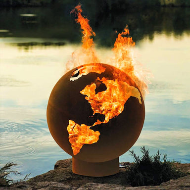 Fire Pit: World Globe lit near lake